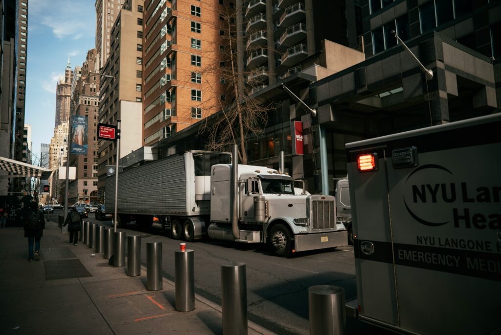 Owner operator truck navigating city street — owner operator health insurance guide