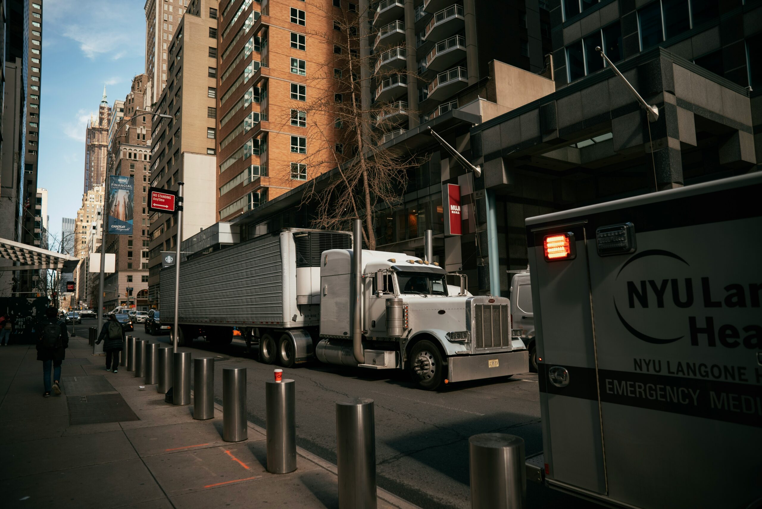 Owner operator truck navigating city street — owner operator health insurance guide